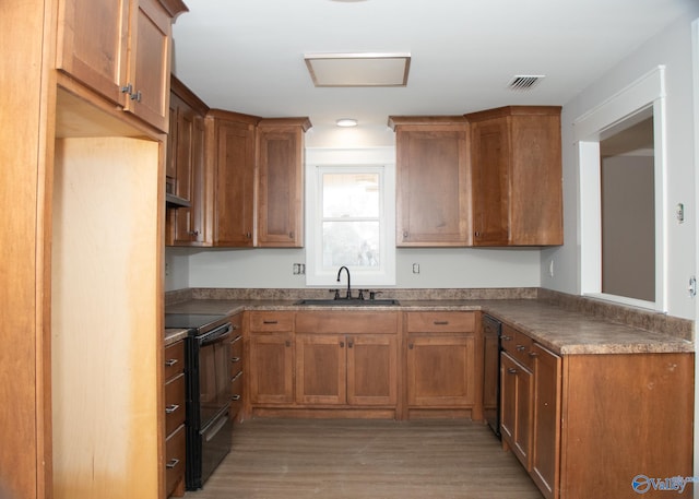 kitchen with electric range, sink, and dark wood-type flooring