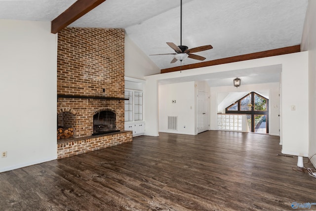 unfurnished living room featuring ceiling fan, dark wood-type flooring, lofted ceiling with beams, a textured ceiling, and a fireplace