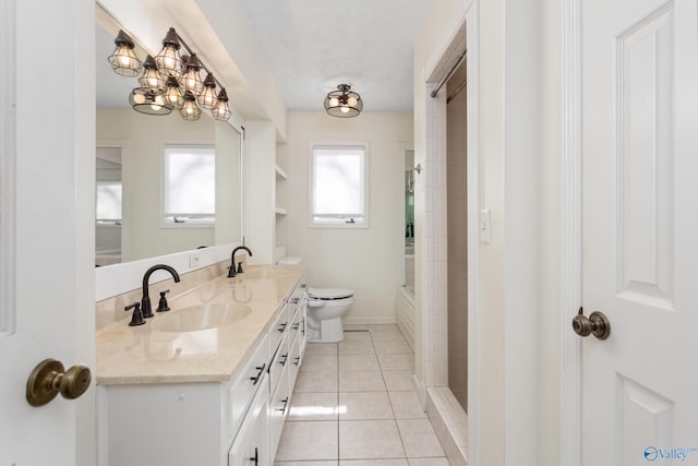 bathroom with tiled shower, tile patterned floors, vanity, and toilet