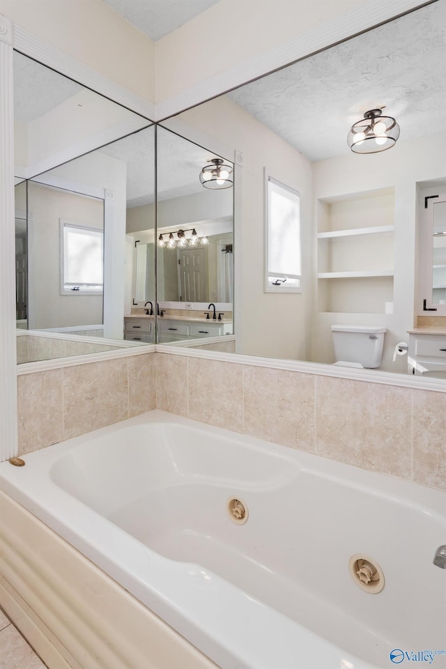 bathroom with built in features, a bathtub, a textured ceiling, and toilet