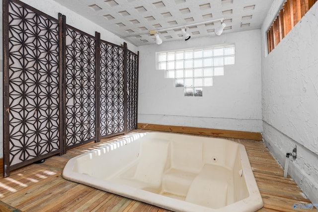 bathroom featuring a tub and hardwood / wood-style flooring