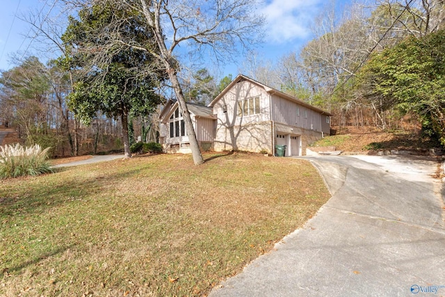 view of property exterior featuring a garage and a yard