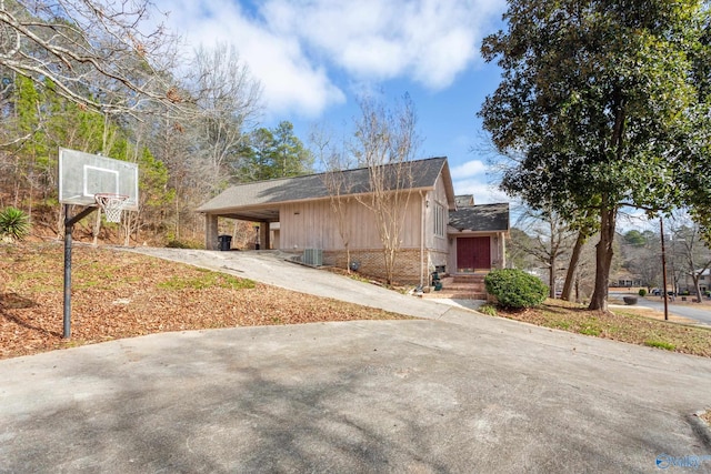 view of side of property with a carport and central air condition unit