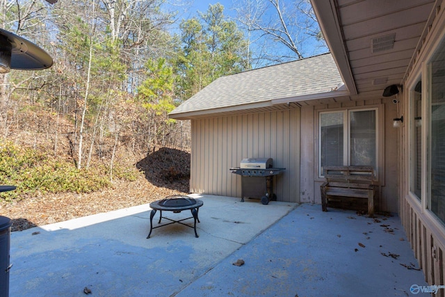 view of patio featuring a grill and an outdoor fire pit