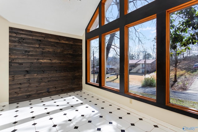 unfurnished sunroom featuring lofted ceiling