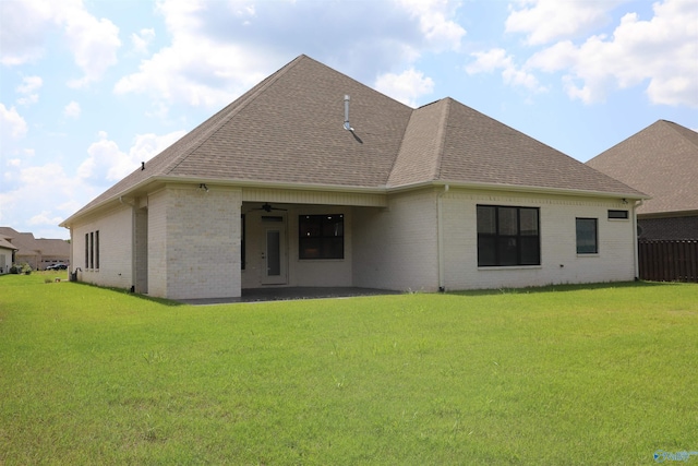 back of property featuring a lawn