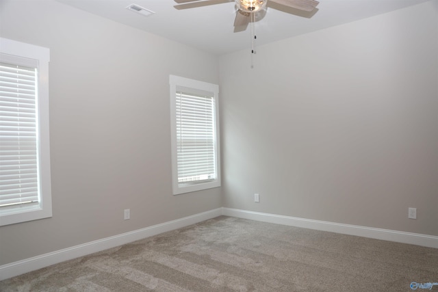 spare room featuring light carpet and ceiling fan