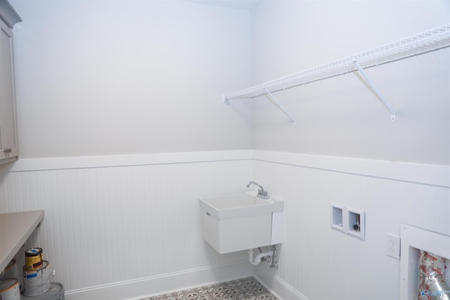 clothes washing area featuring sink, hookup for a washing machine, and cabinets