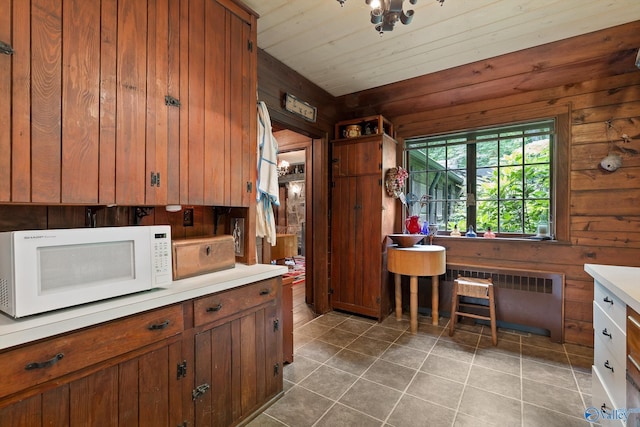 LOT1 Moon Lake Rd, Mentone, AL 35984 - kitchen featuring white microwave, radiator heating unit, wood walls, light countertops, and tile patterned floors