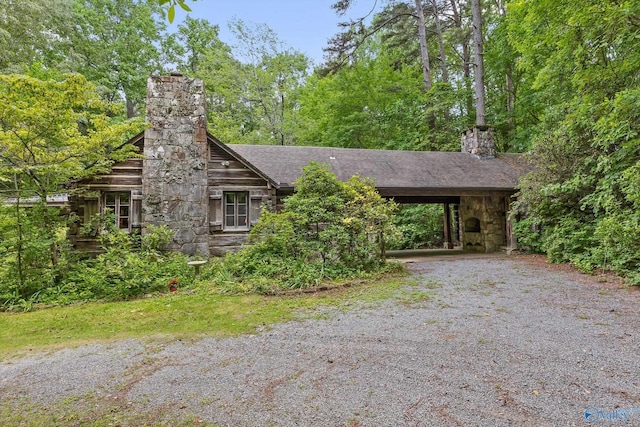 LOT1 Moon Lake Rd, Mentone, AL 35984 - view of front of house with a chimney, roof with shingles, gravel driveway, and an attached carport