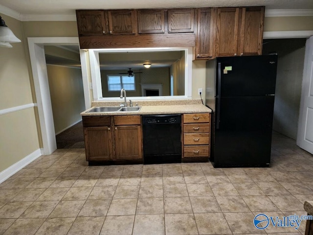 kitchen with crown molding, light tile patterned floors, sink, and black appliances