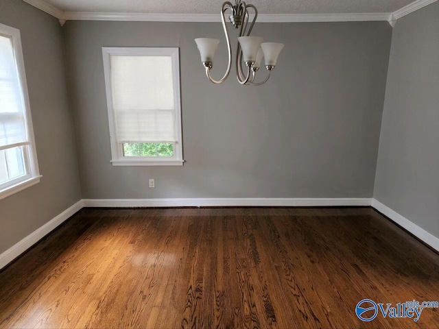 unfurnished dining area featuring ornamental molding, dark wood-type flooring, and a notable chandelier