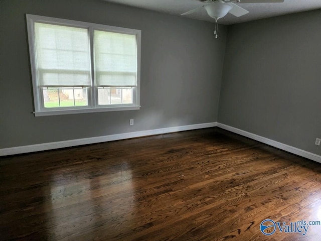 unfurnished room with dark hardwood / wood-style flooring and ceiling fan