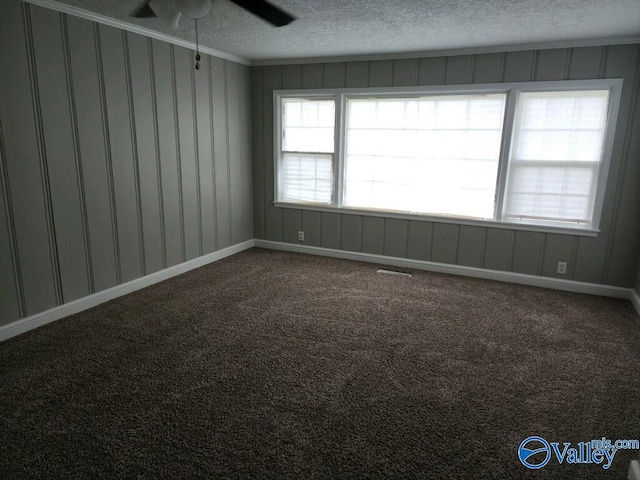 unfurnished room featuring crown molding, ceiling fan, carpet floors, and a textured ceiling