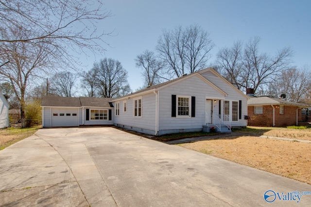 view of front of home featuring a garage, concrete driveway, and crawl space