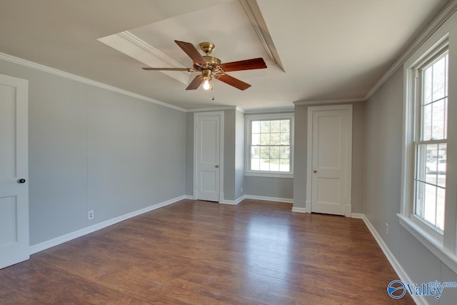 interior space with baseboards, dark wood-style flooring, a ceiling fan, and crown molding