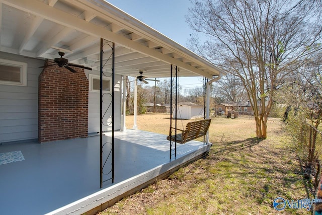 view of yard featuring an outbuilding, a shed, and a ceiling fan