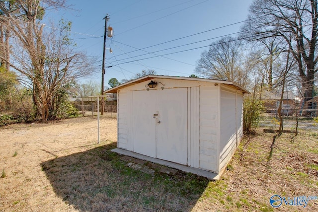 view of shed with fence