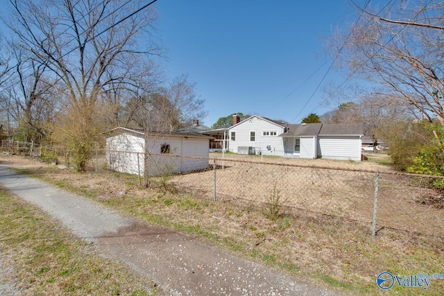 view of property exterior with a chimney and fence