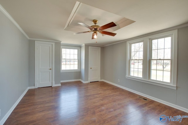 unfurnished bedroom featuring ornamental molding, dark wood-style flooring, visible vents, and baseboards