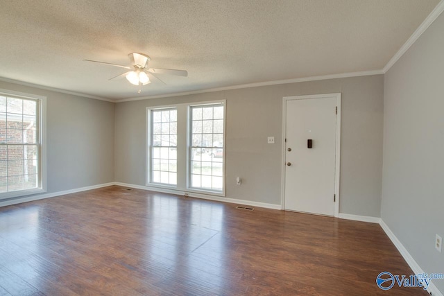 unfurnished room featuring ornamental molding, plenty of natural light, and wood finished floors