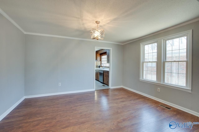 empty room with baseboards, visible vents, dark wood finished floors, an inviting chandelier, and crown molding