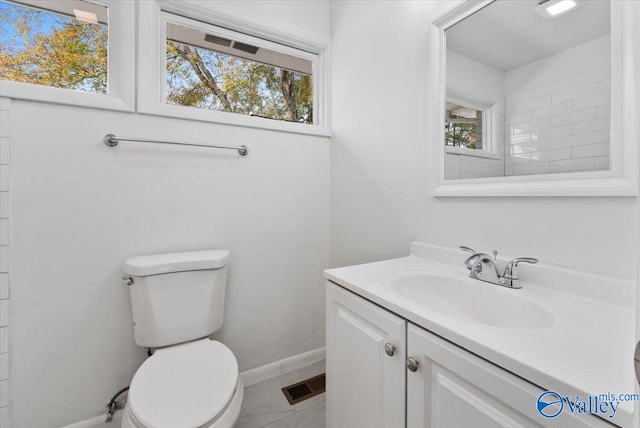 bathroom featuring tile patterned floors, vanity, and toilet