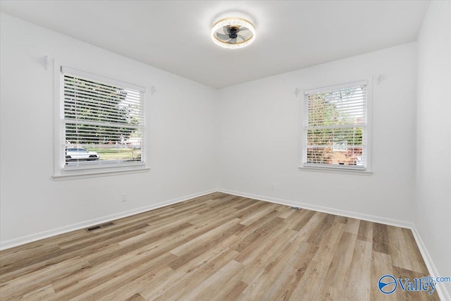 spare room featuring light hardwood / wood-style floors