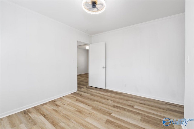 spare room featuring light hardwood / wood-style floors and ornamental molding