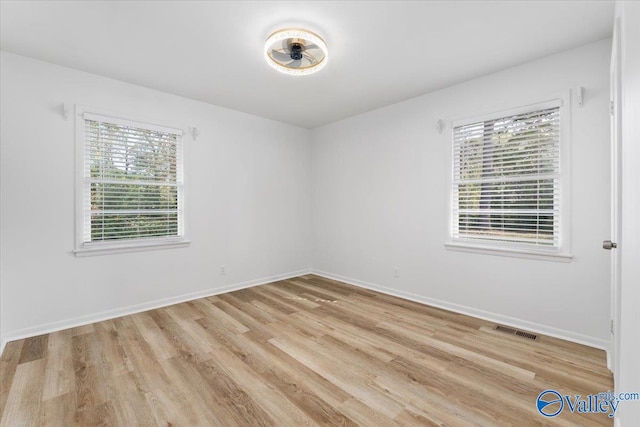 spare room with light wood-type flooring