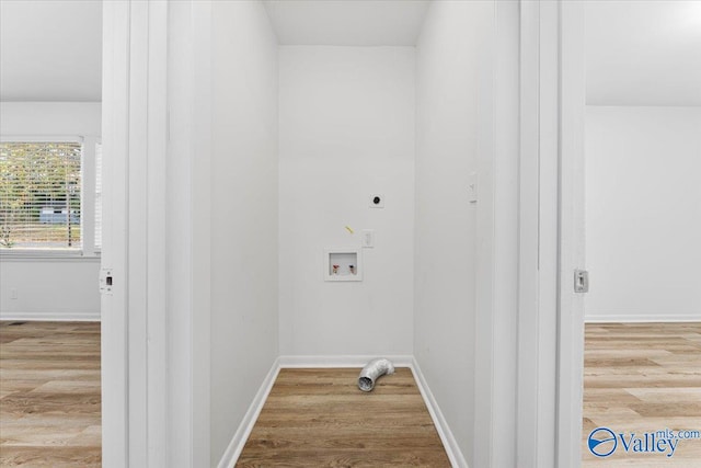 washroom featuring hookup for an electric dryer, light wood-type flooring, and hookup for a washing machine