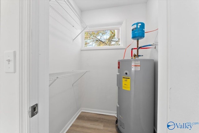 utility room featuring water heater