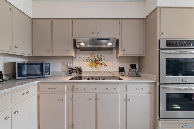 kitchen with tasteful backsplash and appliances with stainless steel finishes