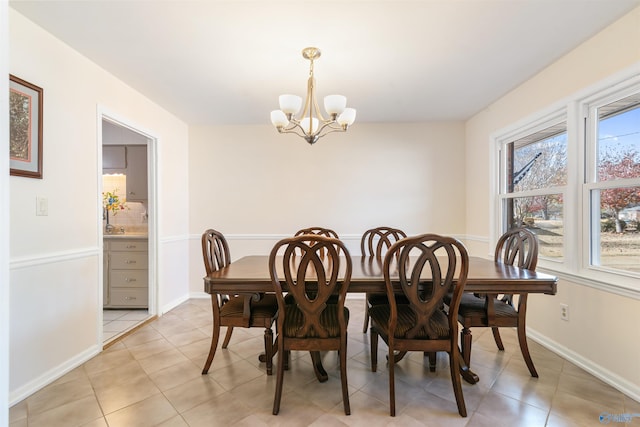 tiled dining space with a chandelier