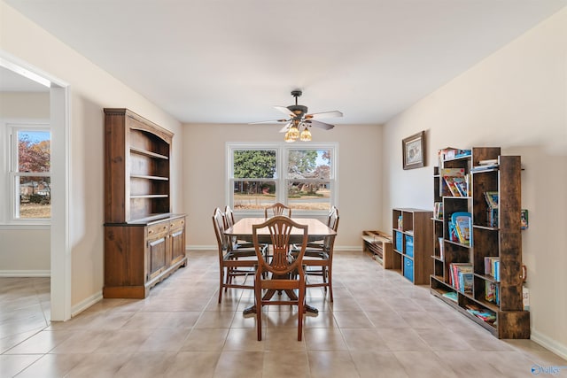 tiled dining room featuring ceiling fan