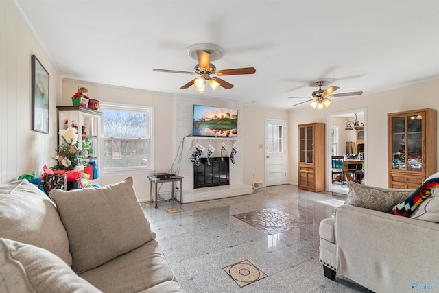 living room with ceiling fan and a brick fireplace