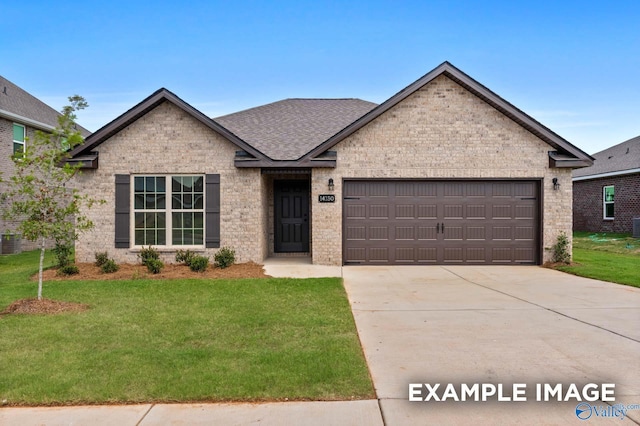 view of front of house featuring a garage and a front yard