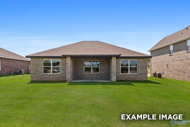 rear view of house with central AC unit, a yard, and a patio