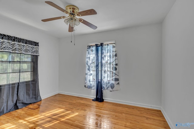 spare room with hardwood / wood-style flooring and ceiling fan