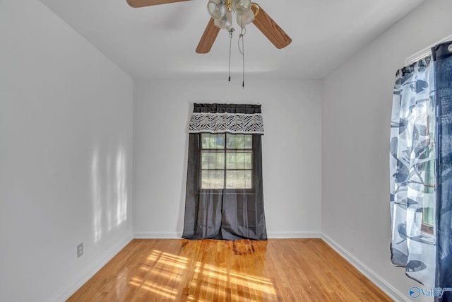 unfurnished room with hardwood / wood-style flooring and ceiling fan