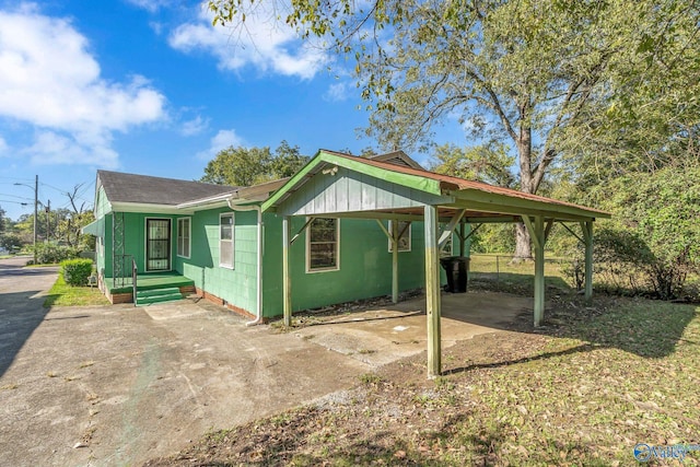 1013 Hermosa Ave, Gadsden, AL 35901 - exterior space featuring concrete driveway, a carport, concrete block siding, fence, and a shingled roof