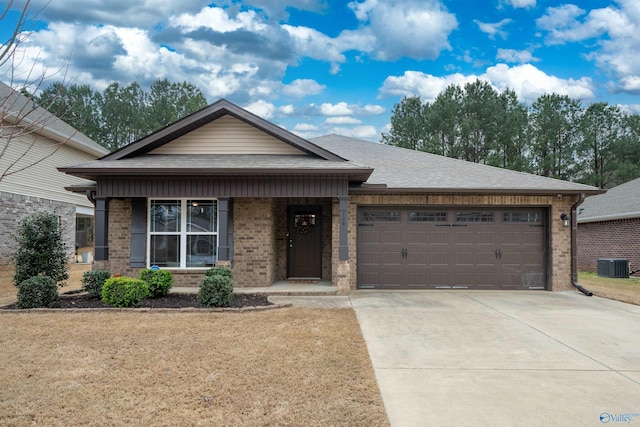 114 Westerbrook Dr, Toney, AL 35773 - view of front facade featuring central AC, an attached garage, brick siding, and driveway