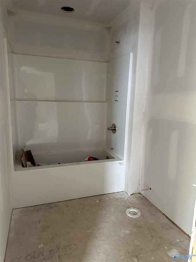 full bath featuring concrete flooring and bathtub / shower combination