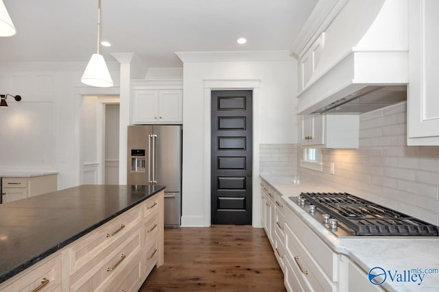 kitchen featuring stainless steel appliances, pendant lighting, white cabinets, backsplash, and custom range hood