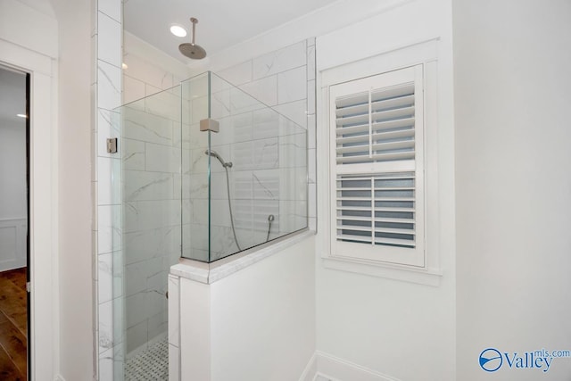 bathroom featuring baseboards and a shower stall