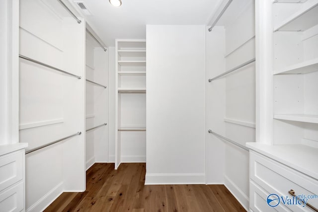 walk in closet with dark wood-style floors and visible vents