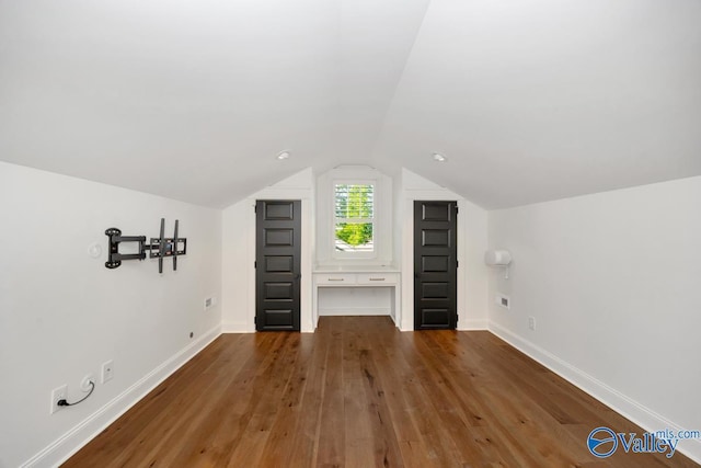 bonus room with vaulted ceiling, baseboards, and wood-type flooring