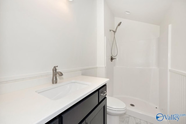 bathroom featuring a shower, marble finish floor, wainscoting, and toilet