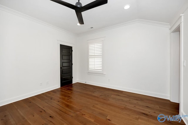 unfurnished bedroom with crown molding, dark wood-style flooring, and baseboards