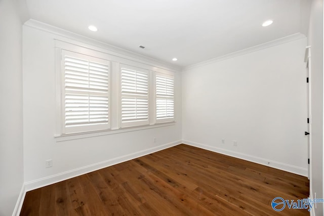 spare room featuring baseboards, recessed lighting, crown molding, and wood finished floors